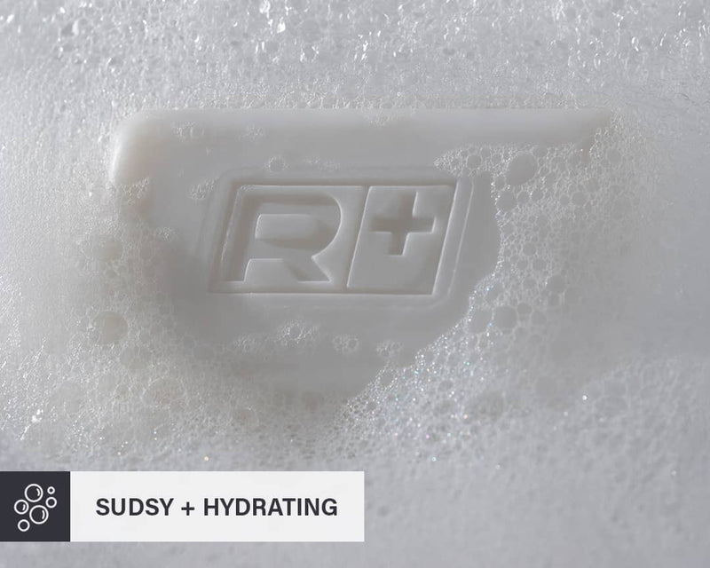 Bar of RGMN+ Gladiator soap on a sudsy white background